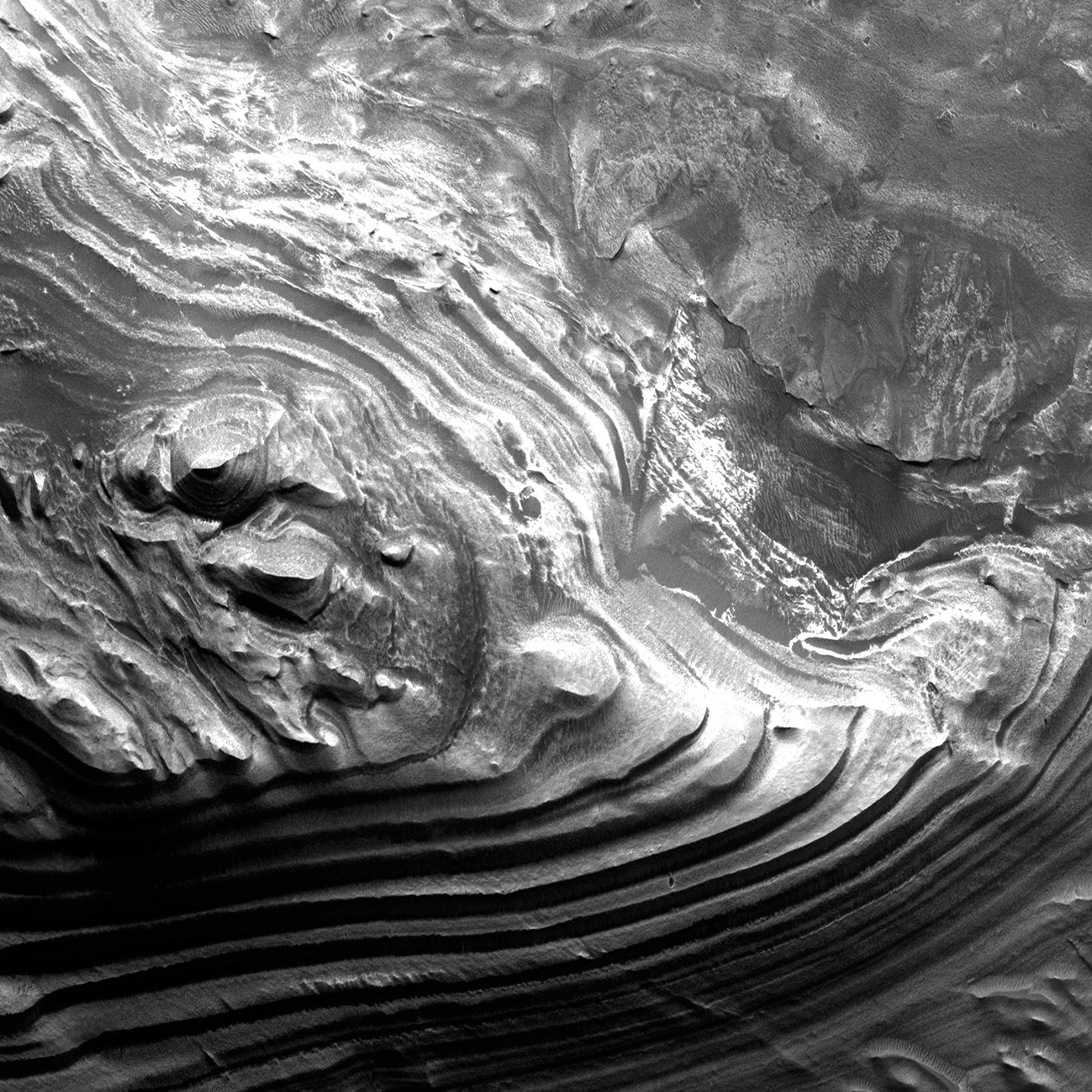 Layered geological formations in Juventae Chasma